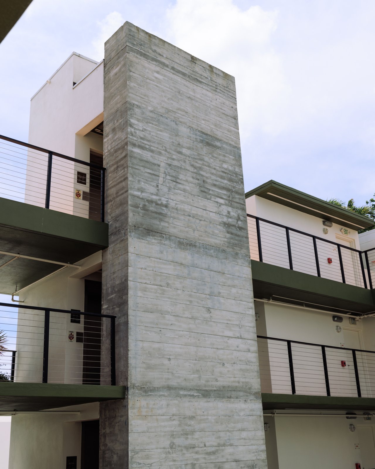 The hotel's Art Deco concrete tower and balconies against the sky, The Balfour Hotel, Miami Beach