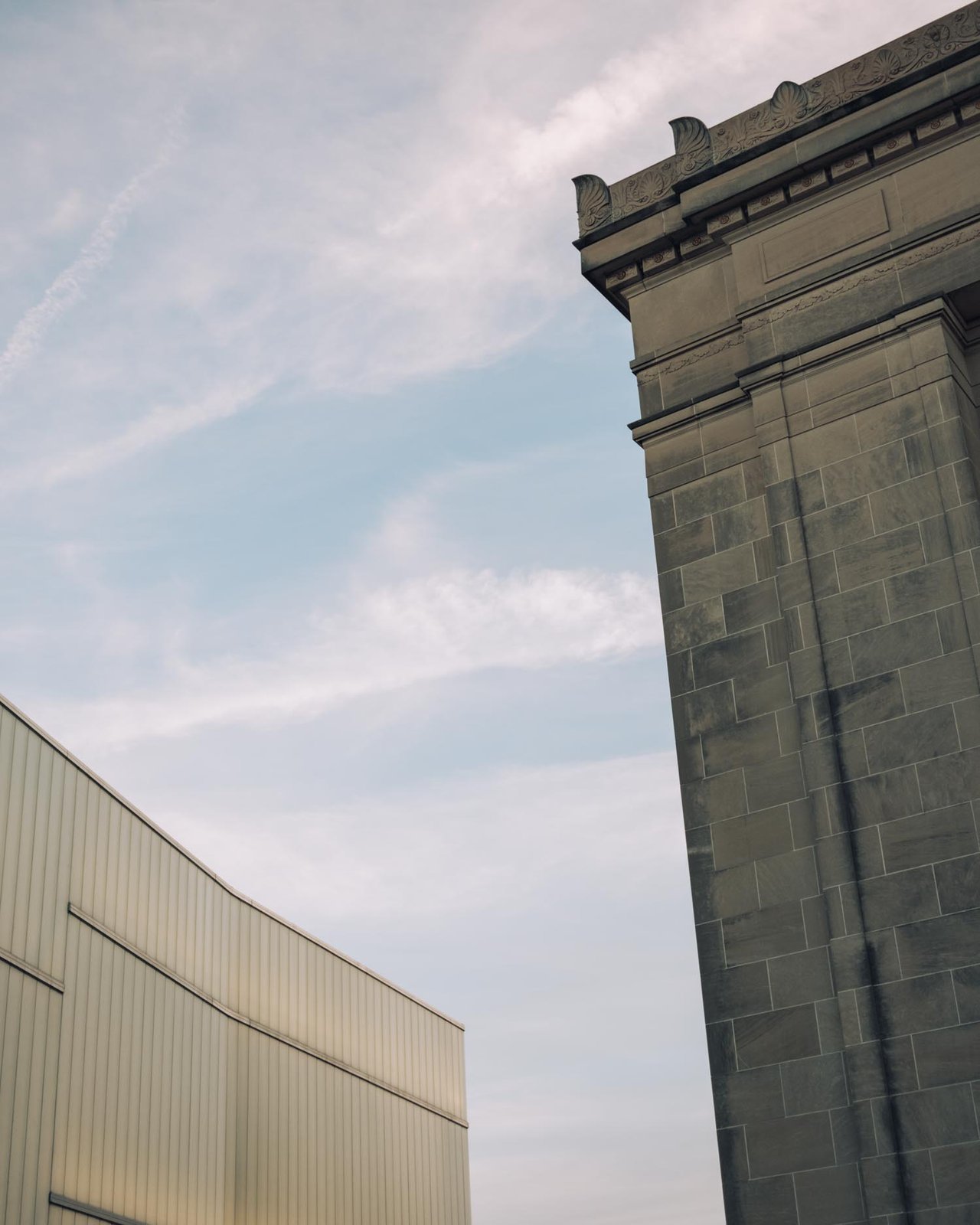 The stone Nelson-Atkins building meeting the modern Bloch Building against the sky, Kansas City