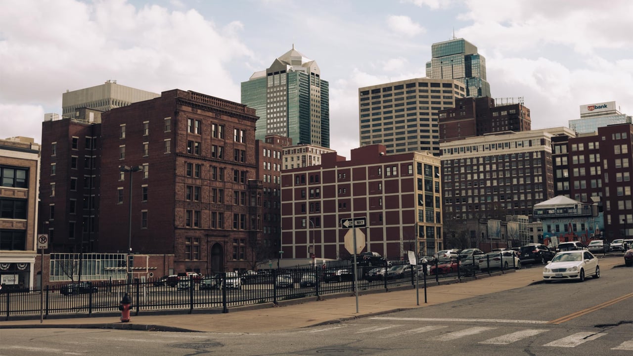 The Kansas City skyline rising over the brick buildings of the Crossroads district