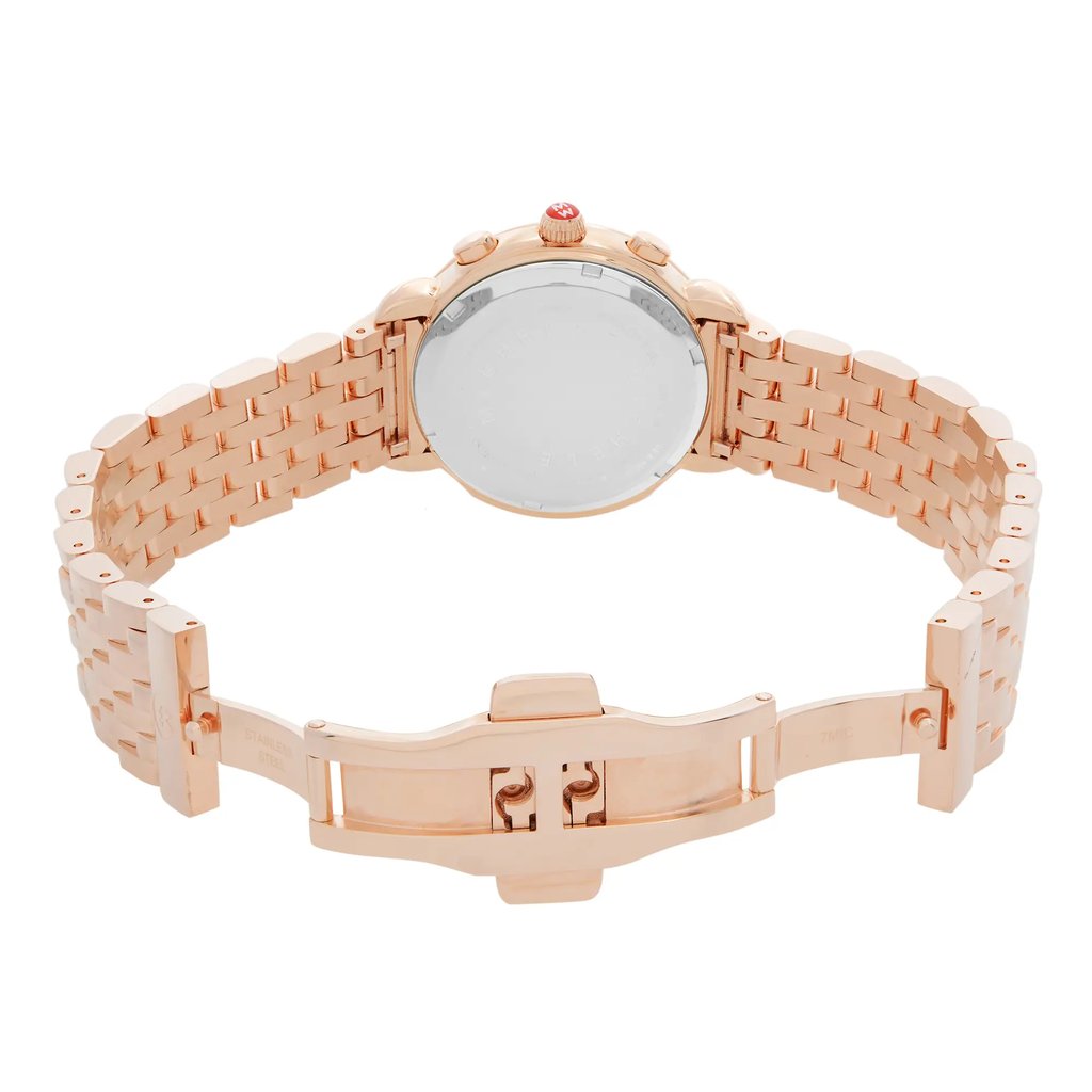 An image of a wristwatch focused on the back view, displaying an open clasp. The watch is positioned at a close distance, revealing intricate details of its rose gold-toned metal bracelet and the smooth back of the watch case. The open clasp is centrally located, showcasing its design and mechanism. The watch is a display model, highlighting its pristine condition and craftsmanship.