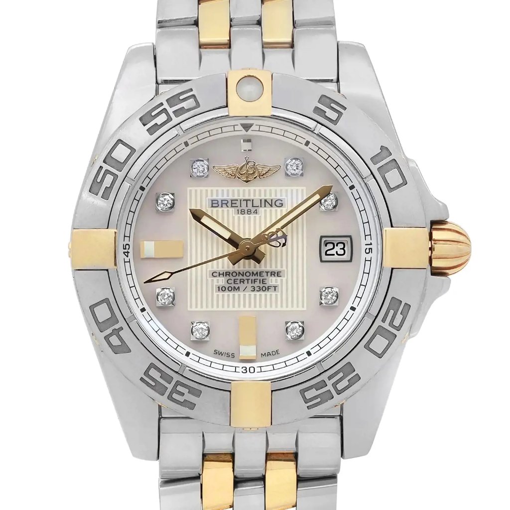 An image of a pre-owned Breitling women's luxury wristwatch, presented in a close-up frontal view highlighting the watch face. The watch features a round shape with a white mother of pearl dial pattern, diamond markers, and stick indexes. The bezel is made of steel and the band combines stainless steel with yellow gold. The Breitling logo and name are visible at the top of the dial, and the hands are in a gold tone. A date indicator is visible at the 3 o'clock position. The overall condition of the watch is classified as good, and the image is taken from a close distance, capturing the watch face and part of the band at a direct angle. The watch is pre-owned and may show minor signs of wear.