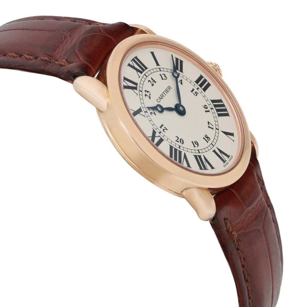An image of a pre-owned wristwatch shown from a side profile view, opposite the crown. The watch features a round, gold-toned case and a white dial with Roman numerals. It is attached to a brown leather strap with visible stitching. The angle highlights the watch's elegant design, providing a close-up perspective.