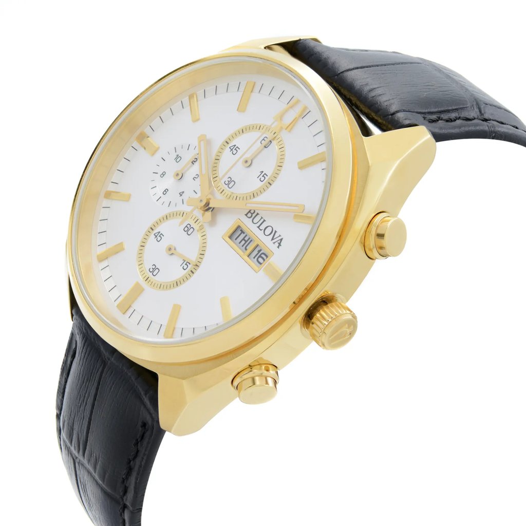 An image of a new-with-defects Bulova men's wristwatch in a casual style, captured from a side profile view emphasizing the crown. The watch features a silver dial with gold-tone hands and markers, and three subdials indicating chronograph functions. The day and date are displayed at the 3 o'clock position. The bezel is yellow gold-tone surrounding a round stainless steel case. The watch is fitted with a black leather band and luminous hands are visible. The image is taken at a close distance, providing a clear view of the watch's details on the right side.