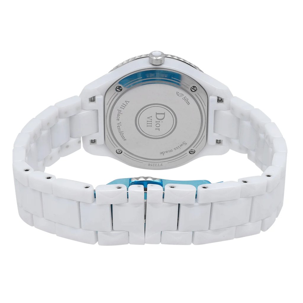 An image of a Dior women's wristwatch, viewed from the back at a close angle. The watch features a round ceramic case with a screwback caseback, visible in the center. The ceramic band and butterfly clasp are prominently displayed, highlighting the smooth, white links. The watch is a display model and includes luminous hands, though not visible from this angle.