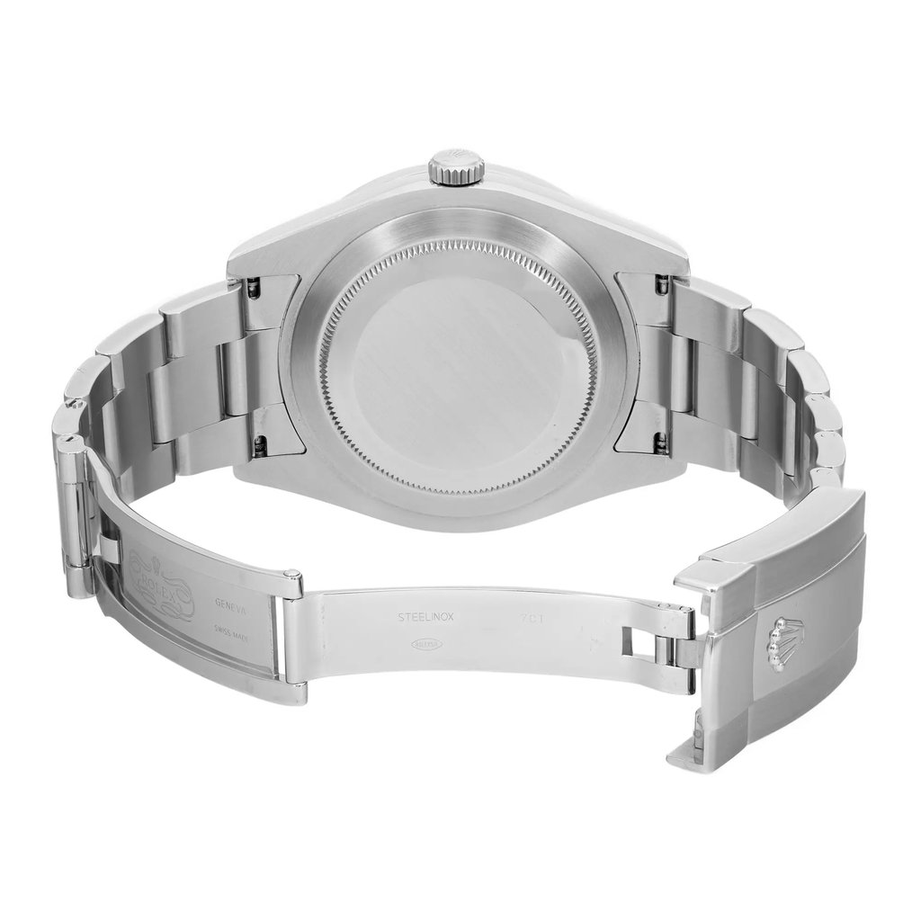An image of a pre-owned wristwatch taken from the back view. The watch has an open clasp and is positioned at eye level, capturing the entire length of the metal bracelet and the smooth, round case back. The angle highlights the intricate design of the bracelet links and the engraved details on the clasp. The photograph is taken from a close distance, focusing on the craftsmanship of the watch.