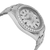 An image of a pre-owned wristwatch viewed from the side profile, opposite the crown. The watch is positioned at a slight angle, showcasing the bracelet and the diamond-encrusted bezel and face. The image is taken from a moderate distance, capturing the detailed embellishments and the watch's sleek design.