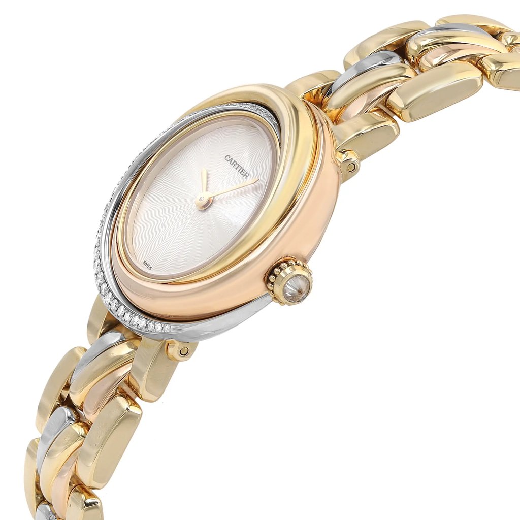 An image of a pre-owned Cartier women's luxury wristwatch viewed from the side, displaying the crown. The watch features a round shape with a white dial, gold bezel, and a band made of interlocking rose gold, white gold, and yellow gold links. The crown is adorned with a clear gemstone and a part of the bezel is set with diamonds. The photo is taken at a close distance, emphasizing the side profile and the intricate details of the watch's design. The case is rose gold, white gold, and yellow gold