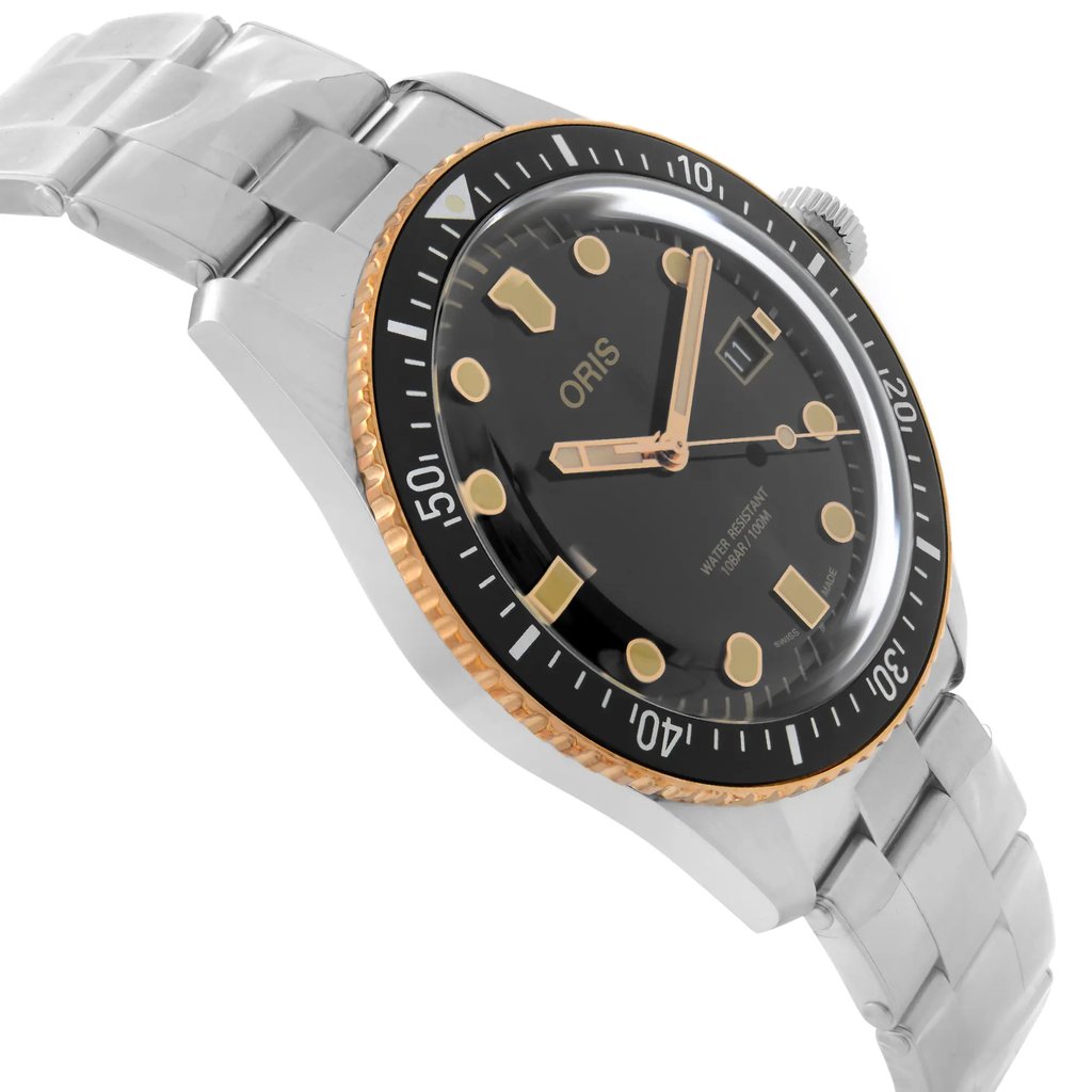 An image of a wristwatch displayed as a side profile view, opposite the crown. The watch features a black dial with gold-tone markers and hands, surrounded by a gold and black bezel. It is attached to a silver metal bracelet. The watch is a display model and is positioned at an angle that highlights its sleek design and craftsmanship.