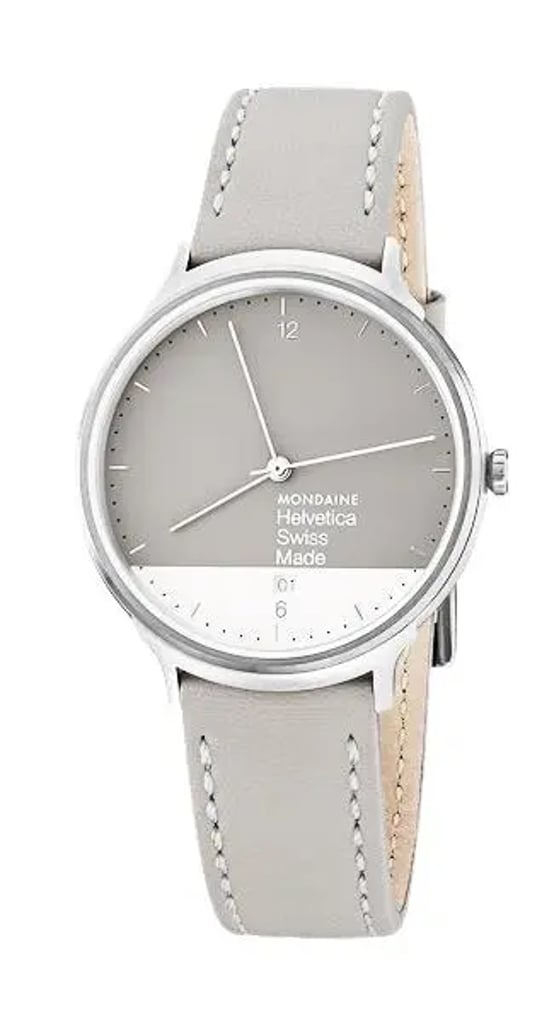 An image of a Wristwatch by Mondaine. This Display Model item is designed for Unisex Adult, featuring a Casual style. It has a Quartz movement and an Analog display with a Gray-White dial color. The indices include 12-Hour Dial,Arabic Numerals,Stick Indexes. The band is made of Leather and the case is made of Stainless Steel. The watch has a Round shape with a case size of 38 mm and a case thickness of 7 mm.