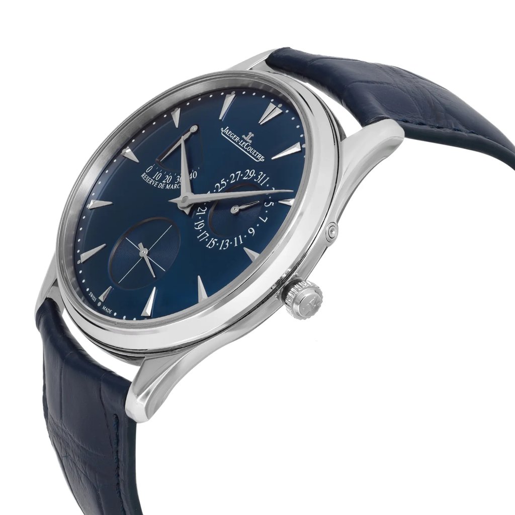 An image of a pre-owned wristwatch viewed from a side profile angle, highlighting the crown on the right side. The watch features a blue dial with silver hour markers and hands. The stainless steel case is polished and paired with a dark blue leather strap. The angle provides a clear view of the watch's thickness and the detailed crown design.