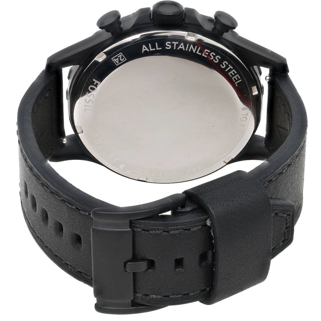 An image of a Fossil wristwatch taken from the back at a slightly elevated angle and close distance. The focus is on the stainless steel case back, with the black leather strap and buckle visible. The watch is new but noted to have defects.