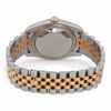 An image of a pre-owned men's Rolex wristwatch, viewed from the rear at a slight angle. The focus is on the back of the watch case and the two-tone metal bracelet, featuring a combination of stainless steel and gold links. The watch is positioned upright with the crown visible at the top, showcasing the craftsmanship and design of the bracelet.