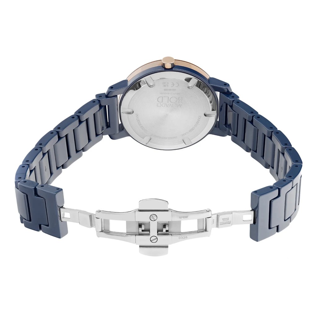 An image of a wristwatch displaying the back view with an open clasp. The watch is positioned centrally, showing the back case and bracelet links clearly. The angle highlights the metallic finish and the engraved details on the back. The watch is a display model, photographed at a close distance to capture the intricate design of the clasp and bracelet.