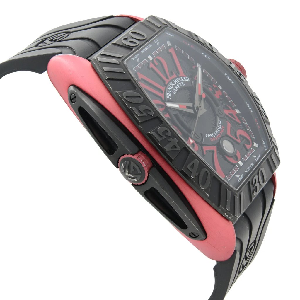 An image of a pre-owned wristwatch shown from a side profile view, opposite the crown. The watch features a bold design with a red case and a black bezel displaying large numerals. The angle highlights the watch's thickness and strap, emphasizing the intricate details on the side. The close-up perspective allows for a clear view of the watch's unique elements and overall craftsmanship.