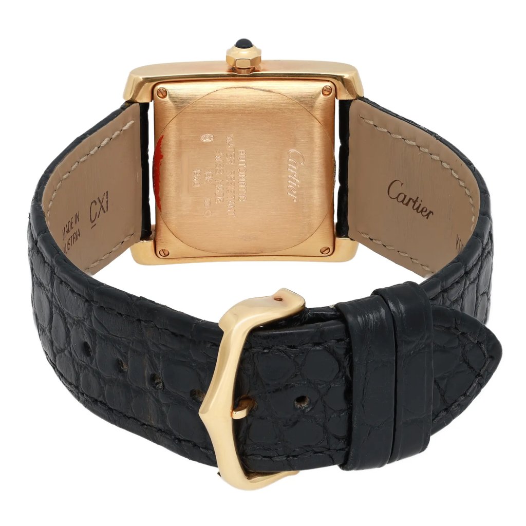 An image of a pre-owned Cartier unisex adult wristwatch, viewed from the back at a slight downward angle, showcasing the gold case and intricate details. The black leather strap is prominently displayed, with the buckle in the foreground. The watch features a date indicator, and the overall condition appears well-maintained.