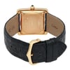 An image of a pre-owned Cartier unisex adult wristwatch, viewed from the back at a slight downward angle, showcasing the gold case and intricate details. The black leather strap is prominently displayed, with the buckle in the foreground. The watch features a date indicator, and the overall condition appears well-maintained.