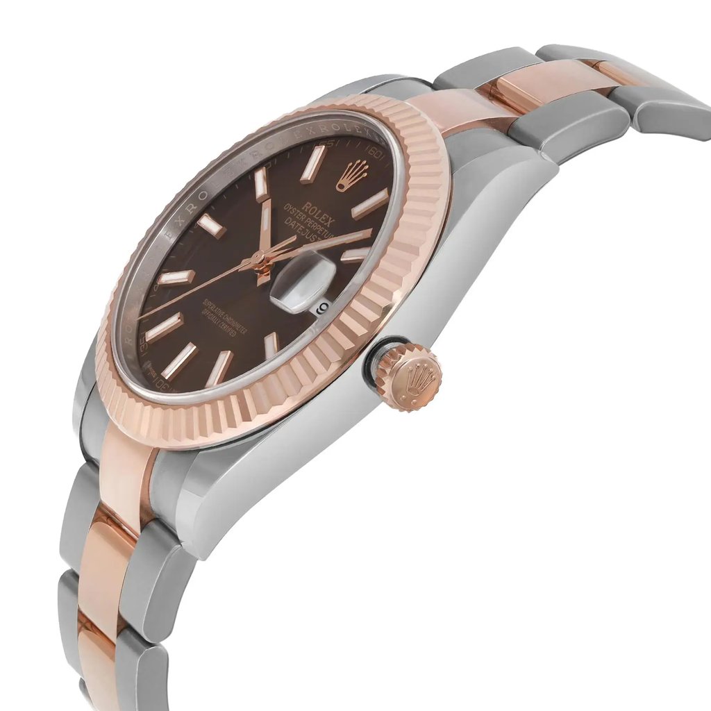 An image of a pre-owned men's Rolex wristwatch viewed from a slight side angle. The watch features a two-tone metal bracelet in stainless steel and rose gold, with a fluted bezel. The dial is brown with luminous hands and a date indicator at the 3 o'clock position. The watch crown is visible on the right side, displaying the Rolex logo. The image is taken from a close distance to highlight the watch's details.