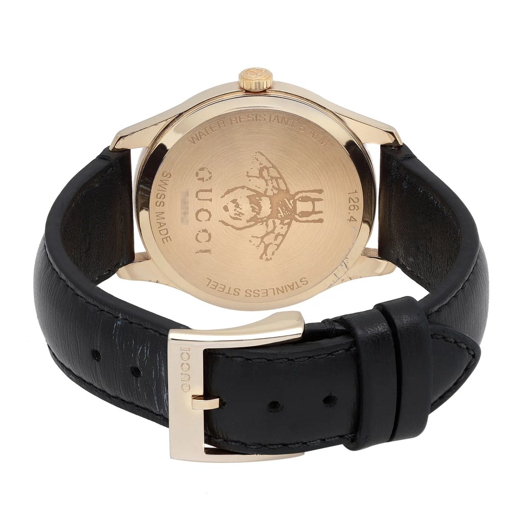 An image of a pre-owned Gucci women's wristwatch showcasing the back view with the clasp closed. The watch is positioned with the caseback facing the camera at a straight angle and the buckle slightly to the right, occupying the middle distance in the frame. The round stainless steel caseback has a snap closure and features an engraved Gucci logo and text indicating water resistance and Swiss made quality. The black leather band loops through a gold-tone buckle with the Gucci brand name.
