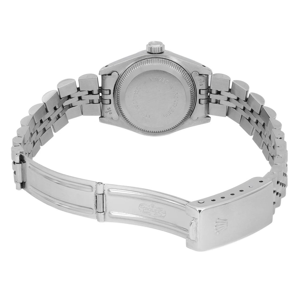 An image of a pre-owned wristwatch taken from a back view, showcasing its open clasp. The angle captures the watch from a slightly elevated position, focusing on the metal bracelet and the back of the watch case. The distance is close enough to highlight the details of the clasp and the engraved markings on the case back. The watch is positioned centrally, with the bracelet extending outward.