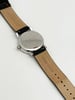 An image of a Wristwatch by Mondaine. This Pre Owned item is designed for Unisex Adult, featuring a Casual style. It has a Quartz movement and an Analog display with a White dial color. The indices include 12-Hour Dial,Stick Indexes. The band is made of Leather and the case is made of Stainless Steel. The watch has a Round shape with a case size of 35 mm and a case thickness of 9 mm.