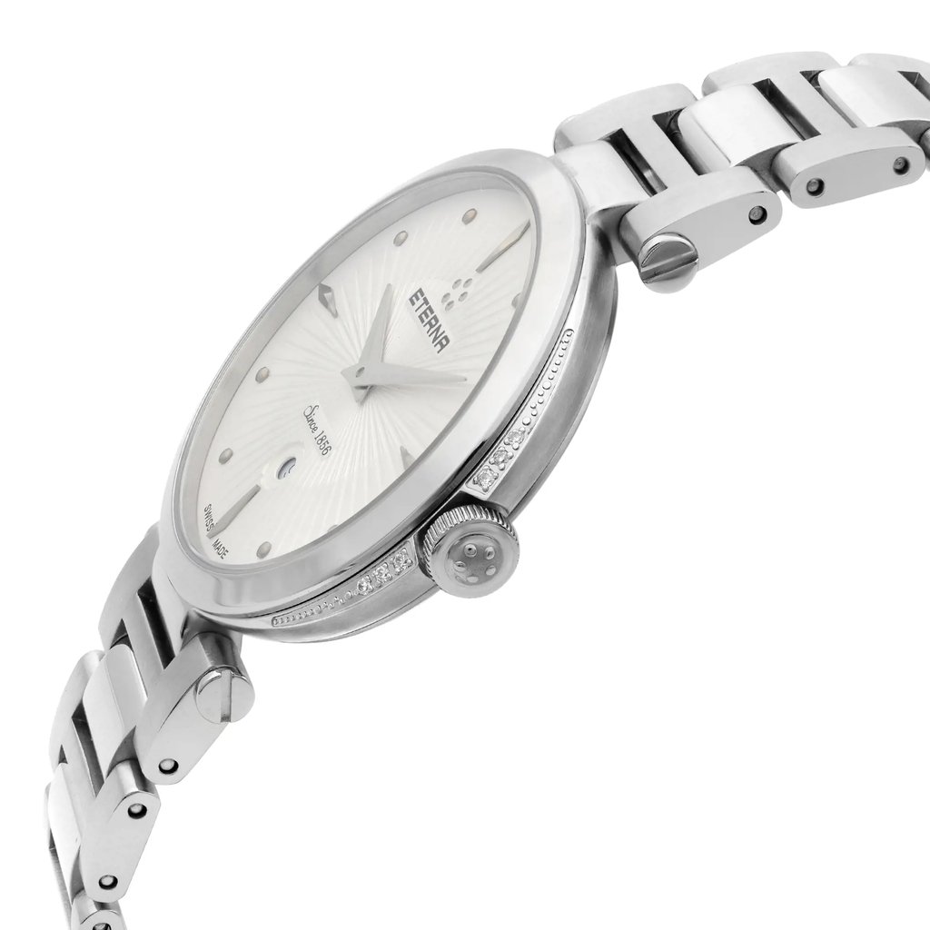 An image of a wristwatch taken from a side profile view, showcasing the crown prominently. The watch face is slightly angled, providing a clear view of the dial and its details. The image focuses closely on the watch, highlighting its metallic bracelet and display model condition.