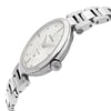 An image of a wristwatch taken from a side profile view, showcasing the crown prominently. The watch face is slightly angled, providing a clear view of the dial and its details. The image focuses closely on the watch, highlighting its metallic bracelet and display model condition.