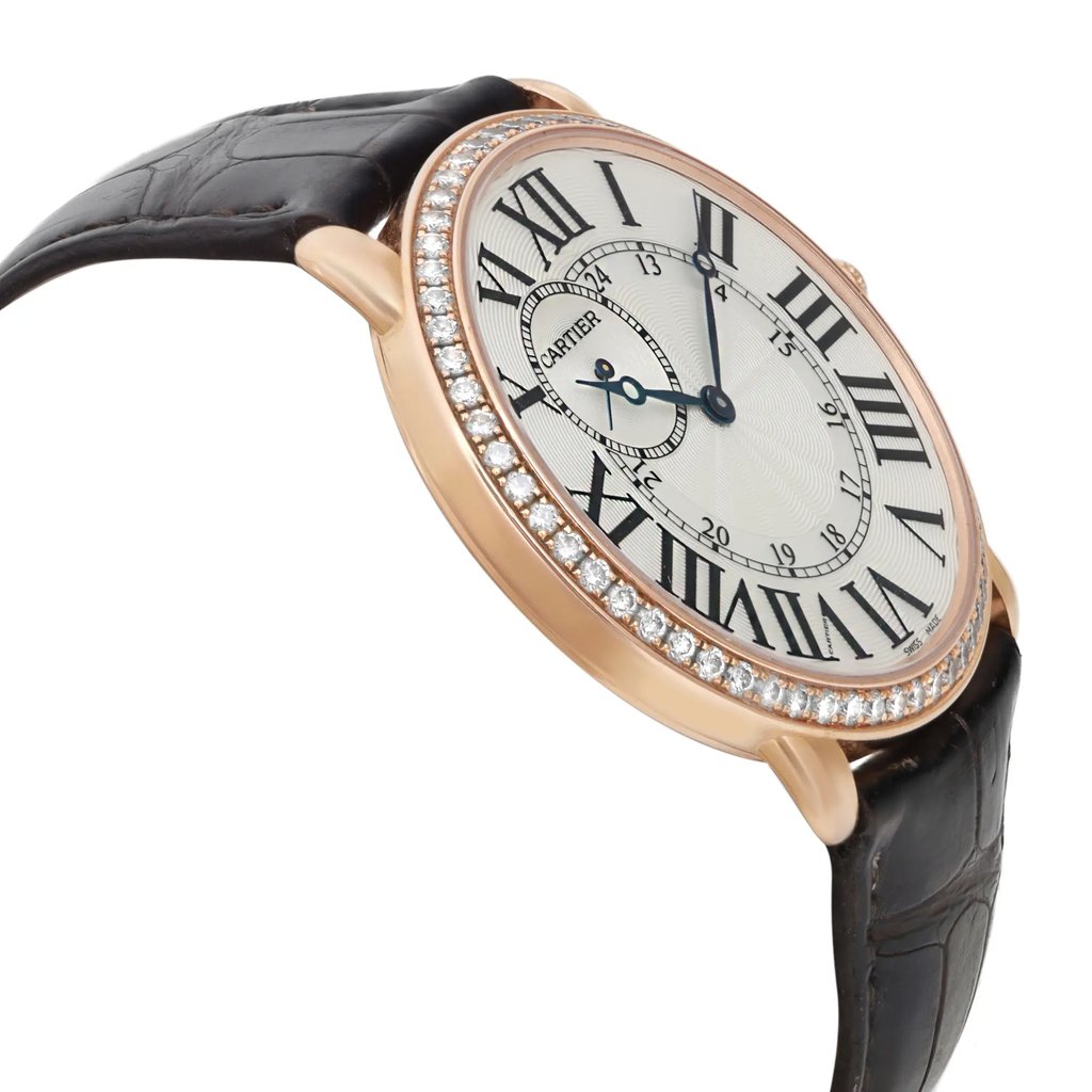 An image of a pre-owned wristwatch captured from a side profile view, opposite the crown. The watch features a round face with Roman numerals and is surrounded by a bezel adorned with small diamonds. It has a black leather strap, and the angle showcases the elegant design and detailing of the watch face. The image is taken from a close distance, highlighting the craftsmanship.