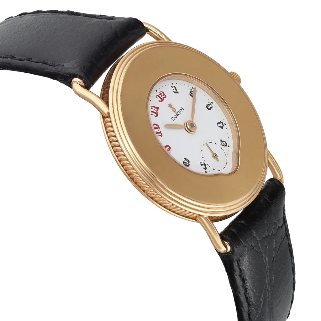 An image of a pre-owned wristwatch viewed from the side profile, opposite the crown. The watch features a gold-toned case with a white dial, displaying red and black numerals. It is positioned at a slight angle, showcasing the textured edge of the case and black leather strap. The distance provides a close-up of the watch’s design details.