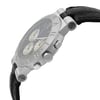 An image of a pre-owned wristwatch captured from a side profile view, highlighting the crown and pushers prominently. The watch features a metallic case with engraved markings on the bezel. The angle emphasizes the watch's thickness and details, while the black leather strap is partially visible. The photo is taken at a close distance, providing a clear view of the design and texture.
