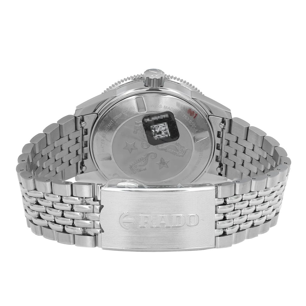 An image of a men's Rado wristwatch displayed from the back view, highlighting the close clasp. The unworn watch features a stainless steel case and band, with a round case shape and a screwback caseback. The band is secured with a fold-over clasp with a double push button. The Rado logo is prominently visible on the clasp. The angle and distance provide a clear view of these details.