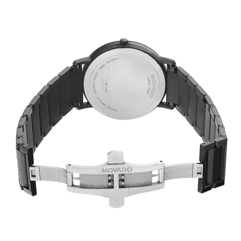 An image of a wristwatch taken from the back view, showing an open clasp. The watch features a sleek, black metal bracelet and a round stainless steel back case engraved with branding details. The angle is slightly elevated, providing a clear view of the open clasp mechanism. The photo is taken from a close distance, highlighting the design and craftsmanship of the display model.