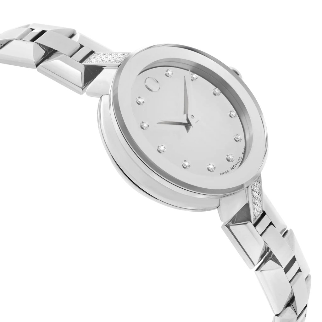 An image of a wristwatch taken from a side profile view, opposite the crown. The watch is positioned at a slight angle, showcasing its sleek, metallic band and minimalist face adorned with small markers. The distance is close enough to highlight details, emphasizing its condition as a display model.