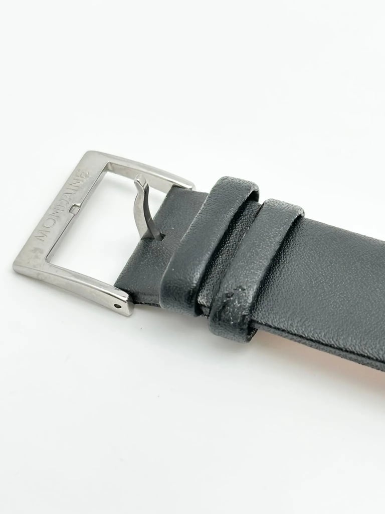 An image of a Wristwatch by Mondaine. This Pre Owned item is designed for Men, featuring a Classic,Dress/Formal style. It has a Quartz movement and an Analog display with a White dial color. The indices include 12-Hour Dial,Non-Numeric Hour Marks,Stick Indexes. The band is made of Leather and the case is made of Stainless Steel. The watch has a Round shape with a case size of 40 mm and a case thickness of 12 mm.