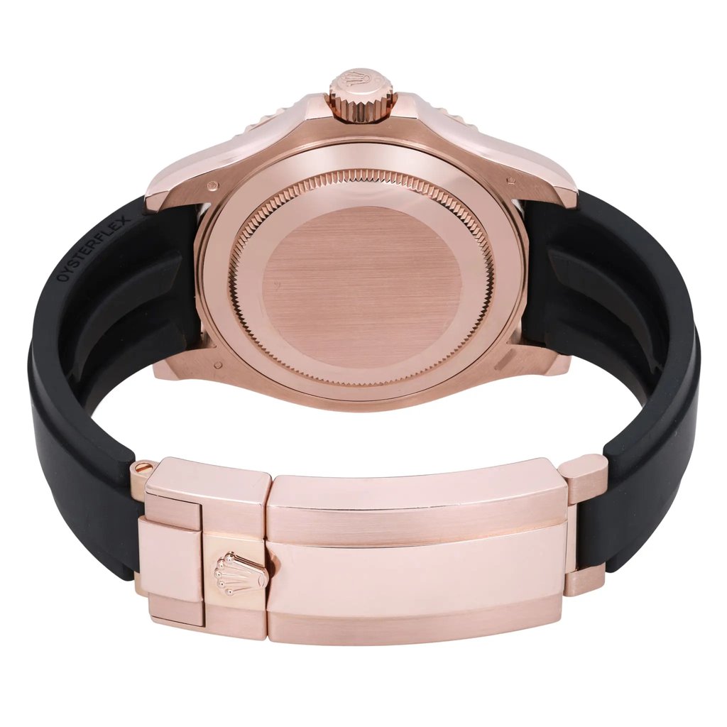 An image of a pre-owned men's Rolex wristwatch, viewed from the back at a close distance. The watch features a rose gold case and a black strap. The angle showcases the closed clasp with the Rolex logo, as well as the screw-down crown. The watch includes features like a date indicator and luminous hands, although these are not visible in this rear view.