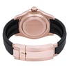 An image of a pre-owned men's Rolex wristwatch, viewed from the back at a close distance. The watch features a rose gold case and a black strap. The angle showcases the closed clasp with the Rolex logo, as well as the screw-down crown. The watch includes features like a date indicator and luminous hands, although these are not visible in this rear view.