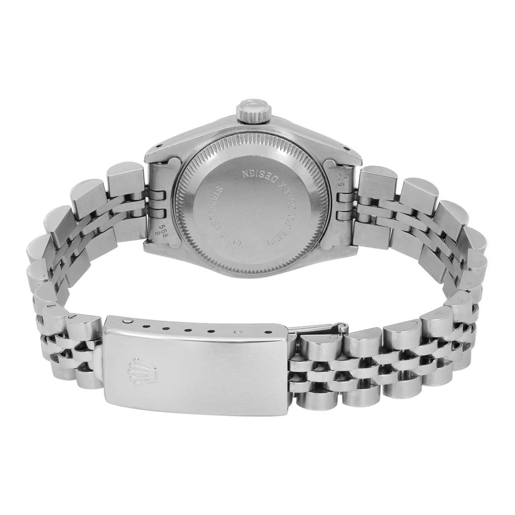 An image of a pre-owned wristwatch shown from the back view. The focus is on the closed clasp and the case back, highlighting the stainless steel bracelet. The watch is positioned at a slight angle, with the image taken from a close distance to emphasize the details of the clasp and the text on the case back.