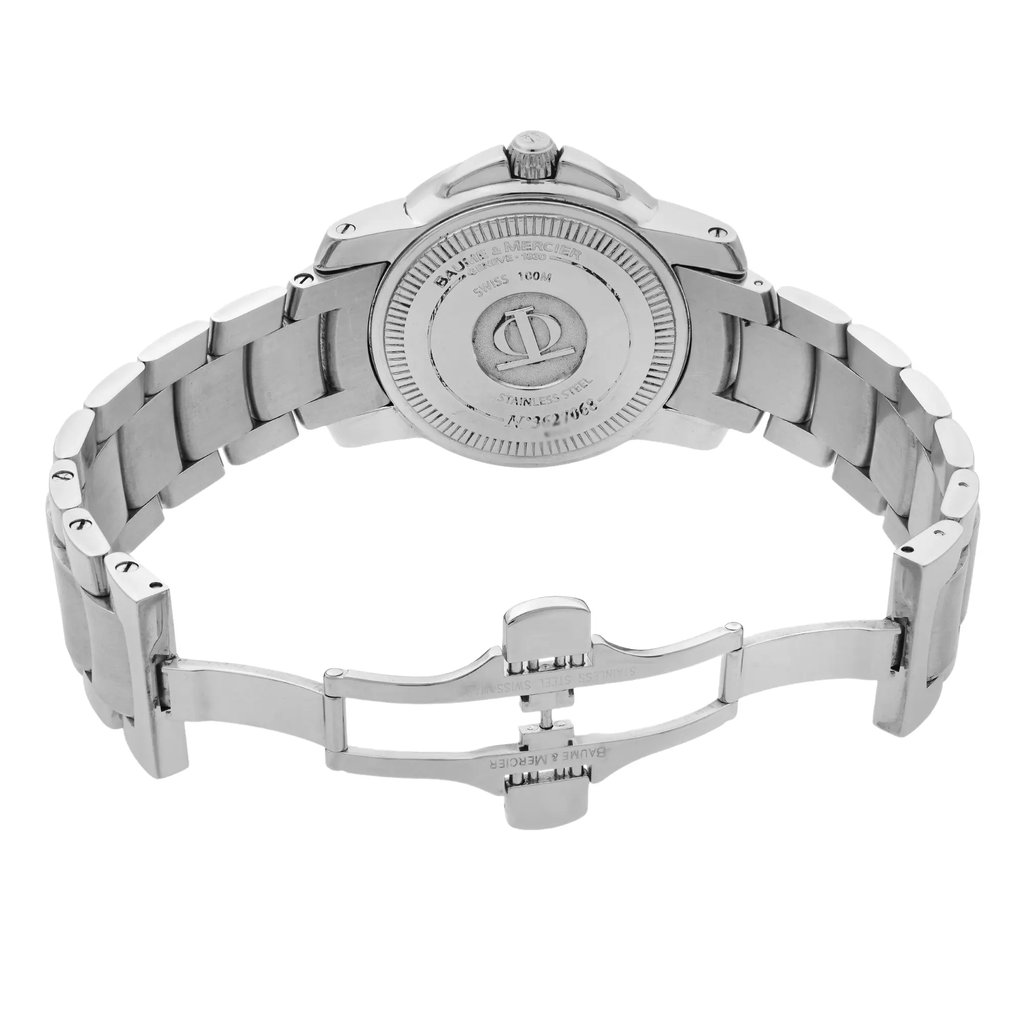 An image of a pre-owned wristwatch viewed from the back, showcasing an open clasp. The watch is positioned upright with the stainless steel band extending outward, displaying its links. The angle highlights the engraved details on the back of the watch case, and the photo is taken from a close distance, emphasizing the clasp mechanism.