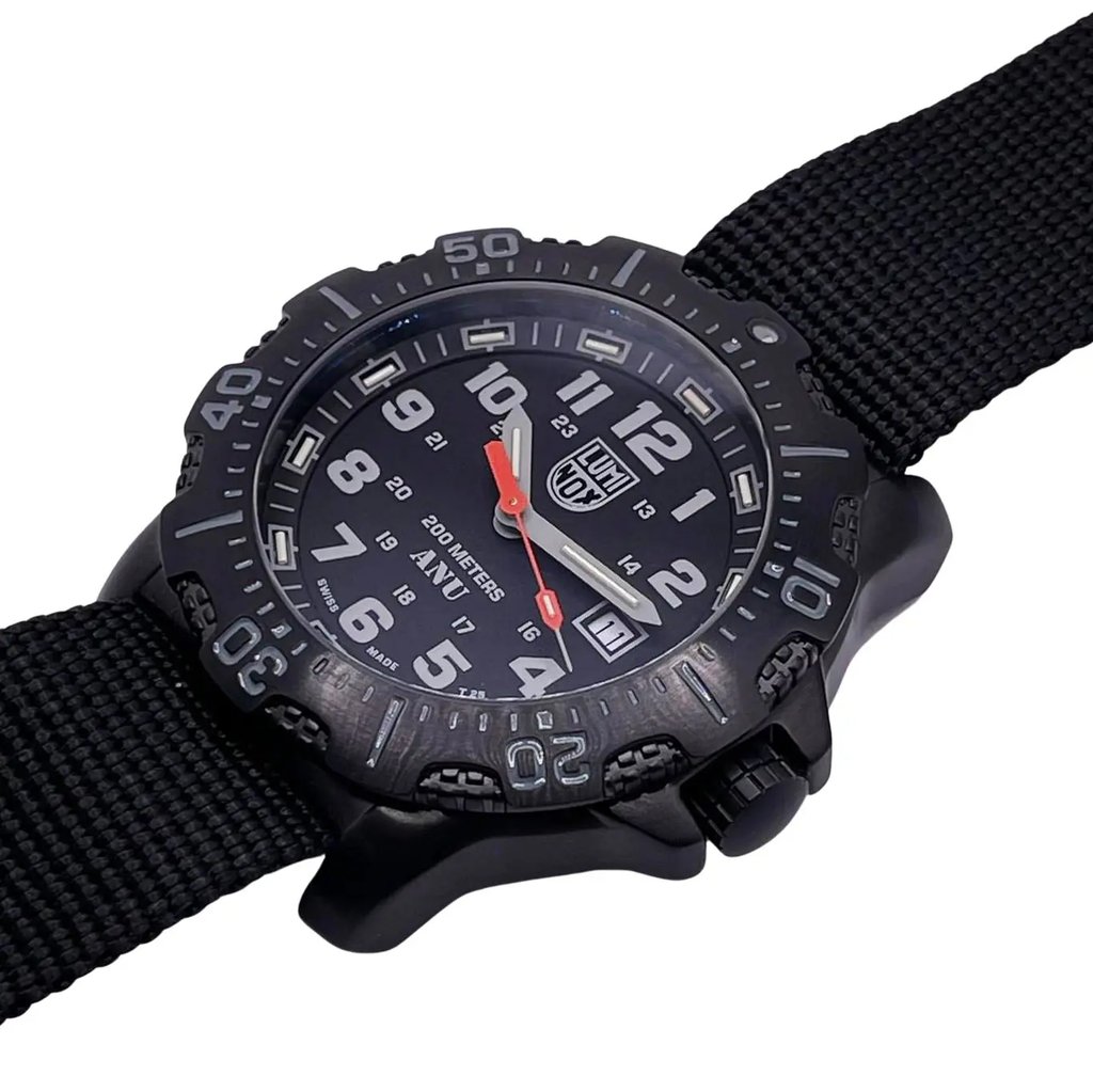 An image of a Wristwatch by Luminox. This Display Model item is designed for Men, featuring a Casual,Diver style. It has a Quartz movement and an Analog display with a Black dial color. The indices include 12-Hour Dial,Arabic Numerals,Easy to Read/Large Numerals. The band is made of Nylon and the case is made of Stainless Steel. The watch has a Round shape with a case size of 45 mm and a case thickness of 14 mm.