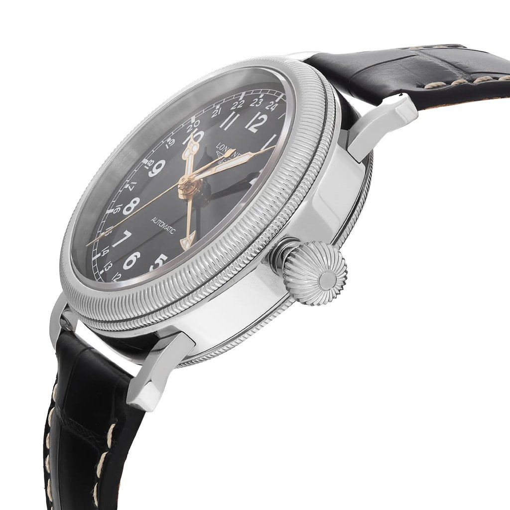 An image of a wristwatch captured from a side profile view, highlighting the crown. The watch features a polished metal case and a black leather strap with visible stitching. The dial is black with white numerals and gold-toned hands. The focus is on the crown, emphasizing its textured design, while the angle provides a clear view of the watch’s thickness and craftsmanship. The image is taken from a close distance, enhancing the detail of the watch's features.