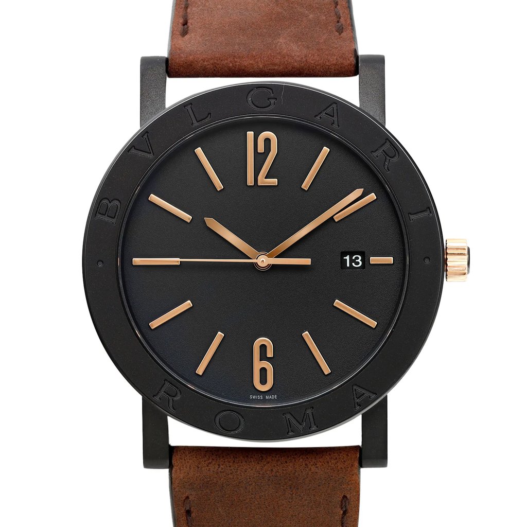 An image of a Bvlgari men's luxury wristwatch, front close-up view displaying a black dial with gold-tone stick indexes and Arabic numerals, set in a round stainless steel case with a black bezel, attached to a brown leather band. The watch is unworn and the face is viewed head-on at a close distance.