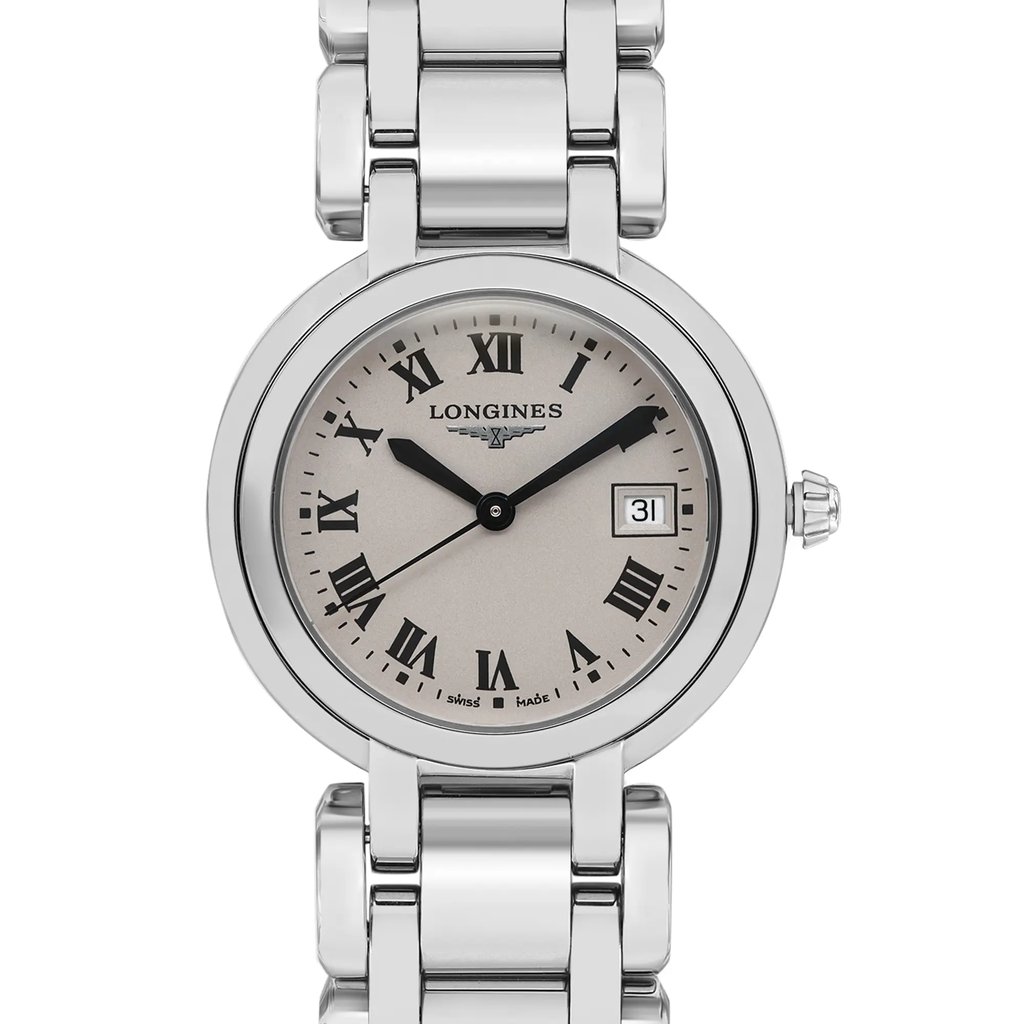 An image of a pre-owned wristwatch shown in a front close-up shot of the watch face. The watch features a silver dial with Roman numerals and black hands. The brand name is displayed on the dial, and a date window is positioned at three o'clock. The metallic bracelet and bezel are clearly visible from the angle.