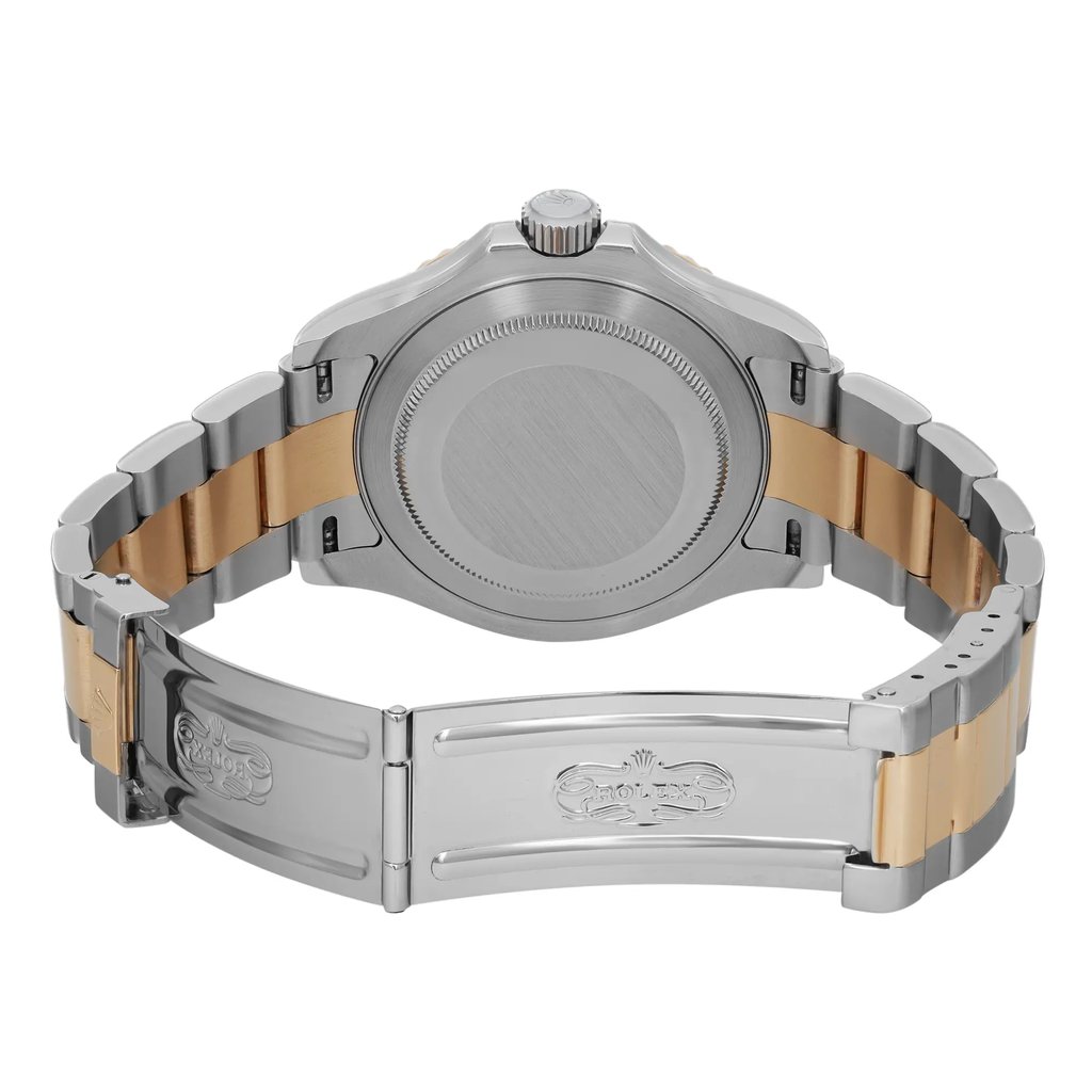 An image of a pre-owned wristwatch showcasing the back view with an open clasp. The watch is positioned at a close angle, highlighting its two-tone metal bracelet with gold and silver links. The focus is on the brushed metal case back and the detailed clasp design, which features engraved logos and motifs.