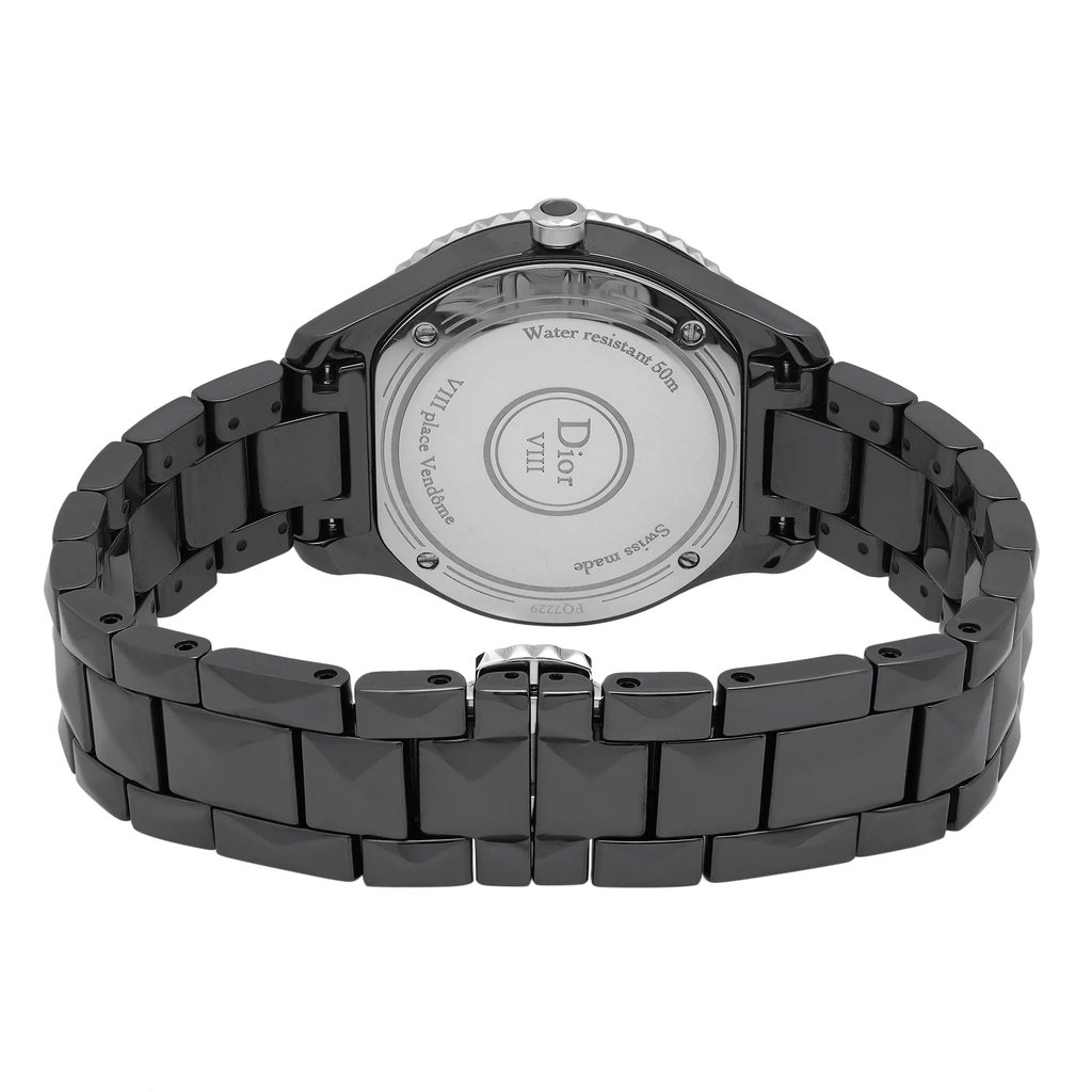An image of a wristwatch taken from the back view, showcasing the closed clasp. The watch is a display model, featuring a sleek metal link bracelet. The angle is slightly elevated, capturing the full back casing of the watch, while the distance is close enough to reveal detailed engravings on the case back.