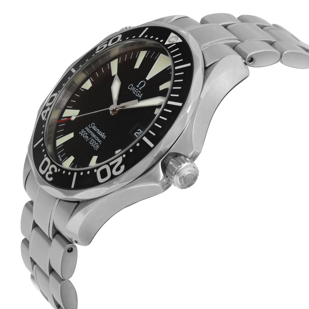An image of a pre-owned wristwatch taken from a side profile view, showcasing the crown prominently. The angle highlights the watch's sleek, polished metallic case and bracelet. The face of the watch, with its distinct markings, is slightly tilted towards the viewer, offering a partial view of the dial and bezel. The photo is captured at a close distance, emphasizing the craftsmanship and design details.