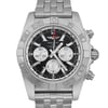An image of a pre-owned Breitling men's luxury wristwatch with a close-up front view of the round black dial and gray bezel. The watch, positioned centrally and facing directly forward, shows a 12-hour dial with stick indexes, small seconds subdial, date indicator, luminous hands, and GMT feature. The stainless steel band and case have light signs of wear. The photograph is taken from a close distance, capturing the intricate details of the watch face and part of the band.