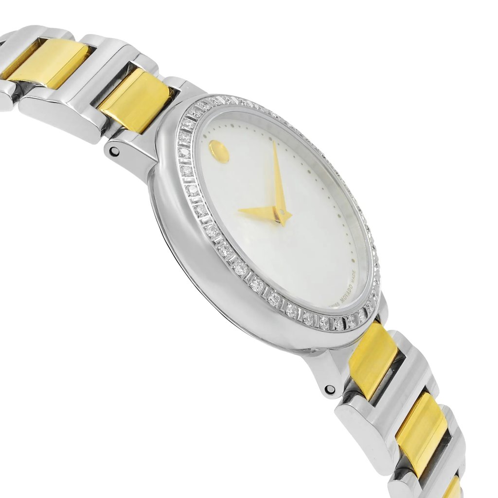 An image of a pre-owned wristwatch captured from a side profile view opposite the crown. The watch features a silver and gold-toned metal bracelet, with a round face surrounded by a bezel adorned with small stones. The dial is simple with gold hands and a minimalist design. The angle highlights the watch's sleek design, focusing on the bracelet and the side of the watch face.