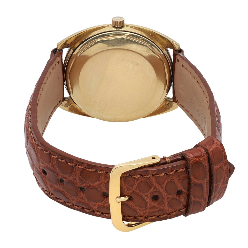 An image of a Wristwatch by Vacheron Constantin. This Pre Owned item is designed for Men, featuring a Classic style. It has a Mechanical (Automatic) movement and an Analog display with a Champagne dial color. The indices include 12-Hour Dial,Stick Indexes. The band is made of Leather and the case is made of Yellow Gold. The watch has a Round shape with a case size of 35 mm and a case thickness of 12 mm.