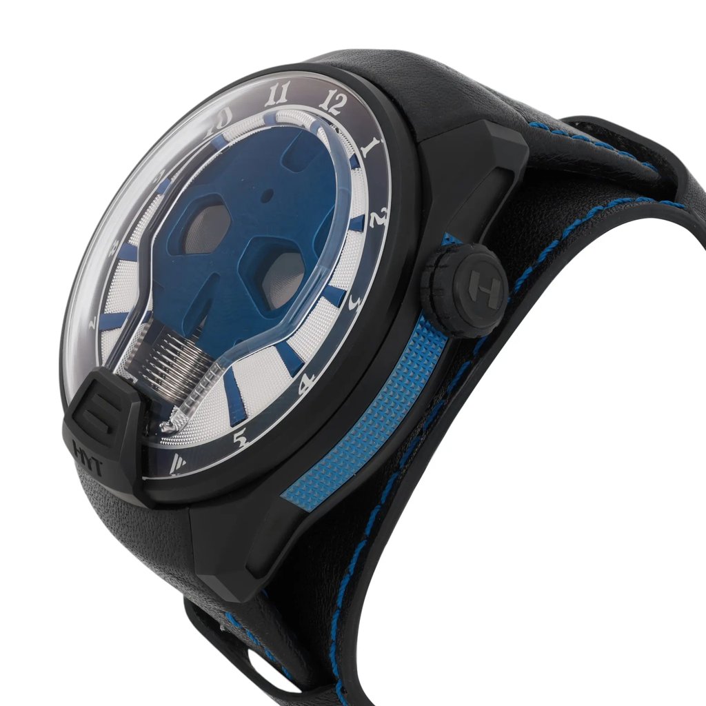 An image of a pre-owned HYT Skull AXL Guns N Roses 51mm Titanium PVD men's wristwatch captured from a slightly elevated side angle. The watch features a prominent, round face with a distinctive skull design in blue, surrounded by hour markers. The case is black, complementing the black strap with blue visible stitching. The crown is visible on the right side, adorned with an "H" emblem. The image is taken at a close distance, showcasing the watch's unique design details.