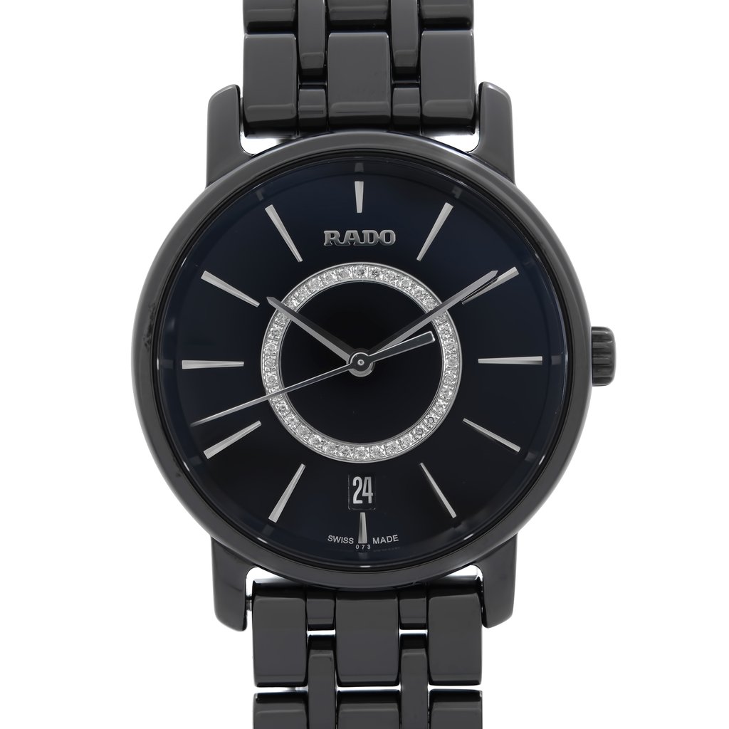 An image of a wristwatch taken from a front close-up angle, focusing on the watch face. The watch is new with defects, featuring a black dial with silver hour markers and a decorative circular pattern. The date is displayed at the 6 o'clock position. The watch has a black metallic link bracelet.