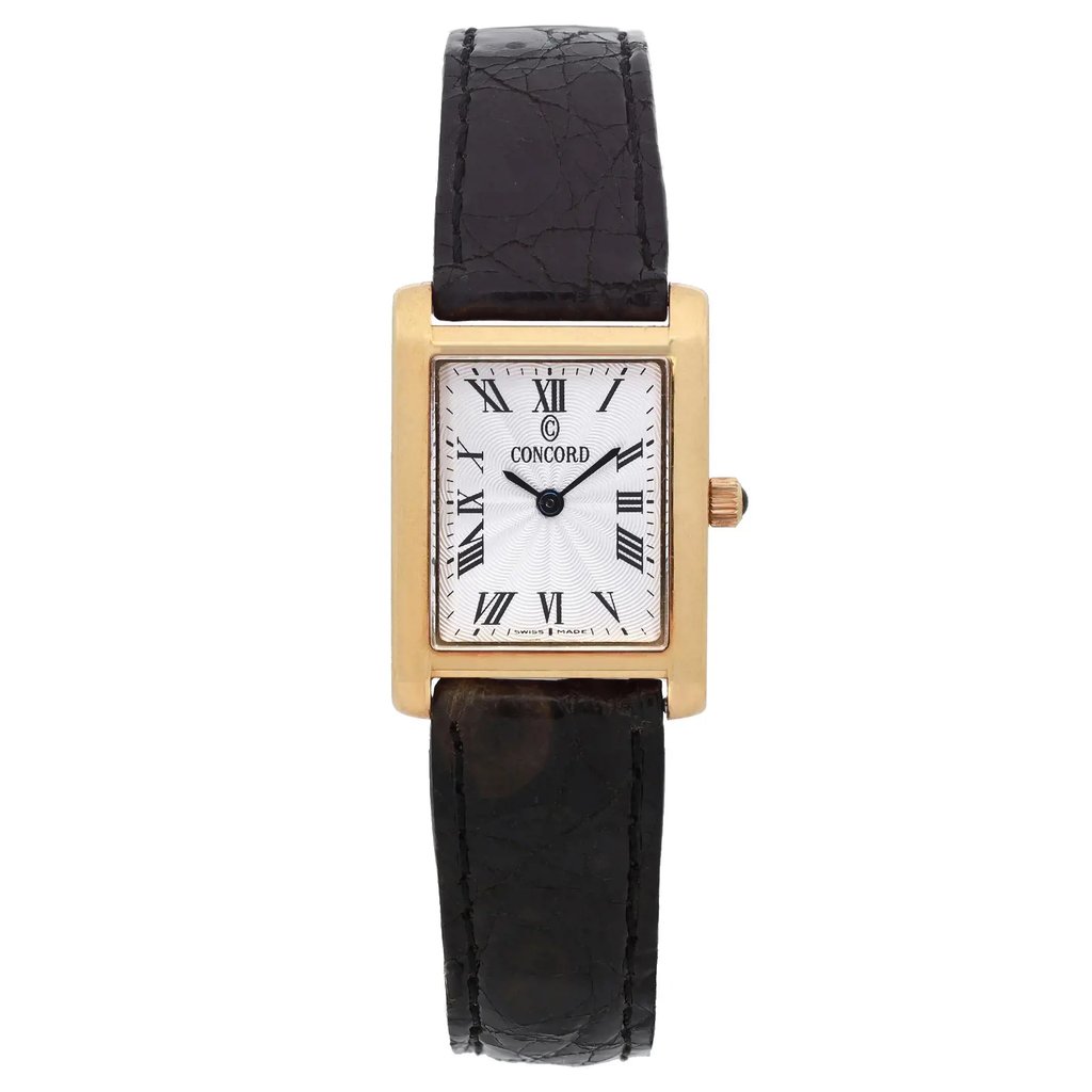 An image of a pre-owned wristwatch taken from a front full frontal view. The watch features a rectangular gold case with a white dial and Roman numeral hour markers. The brand name is visible on the dial. It has a black leather strap with a textured pattern. The image is captured at a close distance, highlighting the details of the watch's face and strap.
